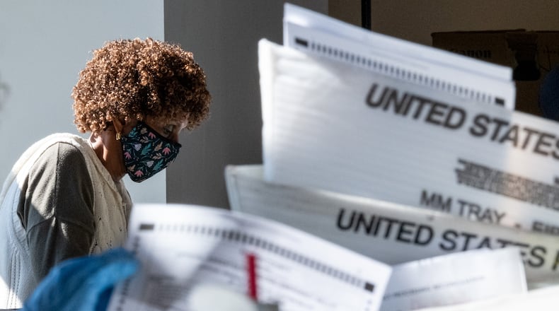 Fulton County elections workers sort absentee ballots at State Farm Arena on Wednesday afternoon, Nov. 4, 2020. Ben Gray for the Atlanta Journal-Constitution