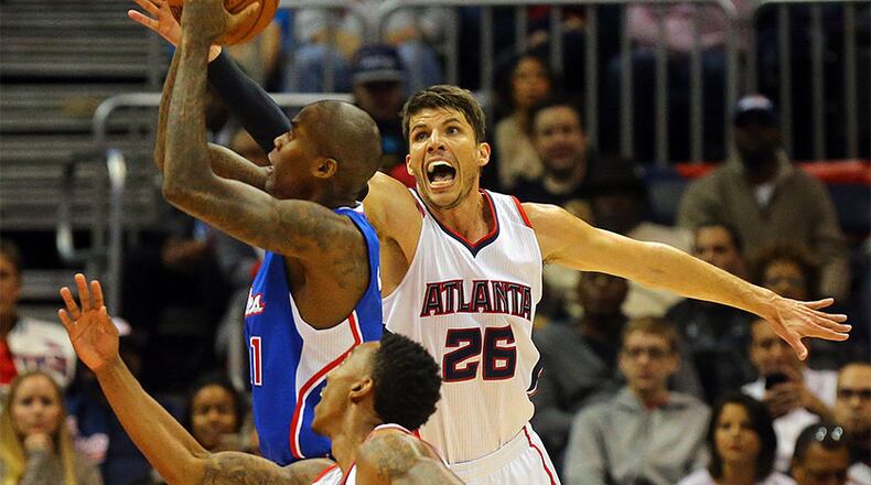 Clippers guard Jamal Crawford gets a shot off as Hawks’ Kyle Korver defends during the first half in a basketball game Dec. 23 at Philips Arena.