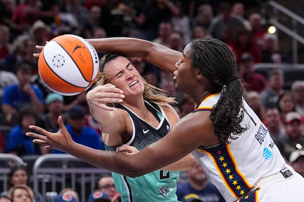 New York Liberty guard Sabrina Ionescu (20) is fouled by Indiana Fever forward Aliyah Boston (7) in the first half of a WNBA basketball game in Indianapolis, Saturday, May 24, 2025. (AP Photo/Michael Conroy)