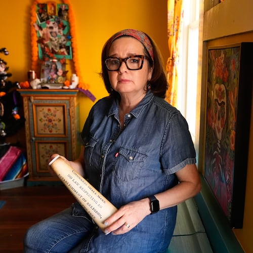 Gigi Cervantes, who resigned from her position as a theater teacher at a Fort Worth school rather than teach in a classroom where the Ten Commandments are hung, poses for a photo at her home, Wednesday, Nov. 5, 2025, in Fort Worth, Texas. (AP Photo/Tony Gutierrez)