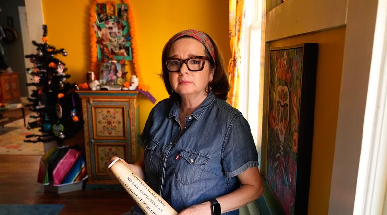 Gigi Cervantes, who resigned from her position as a theater teacher at a Fort Worth school rather than teach in a classroom where the Ten Commandments are hung, poses for a photo at her home, Wednesday, Nov. 5, 2025, in Fort Worth, Texas. (AP Photo/Tony Gutierrez)