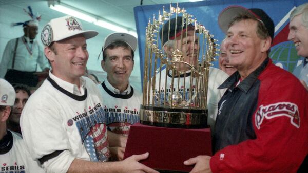 Braves manager Bobby Cox (right) with the fruits of the team's 1995 labor. (AJC Archives)