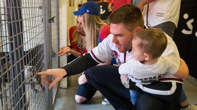 Atlanta Braves baseball player Freddie Freeman held his son Charlie (age 2) as they met dogs during a visit to Best Friends in Atlanta as part of the team's Season of Giving on Wednesday, Dec. 12th, 2018. The animal shelter works collaboratively with area shelters, animal welfare organizations and individuals to save the lives of pets in shelters. (Photo by Phil Skinner)