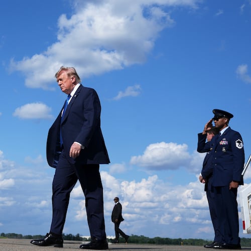 President Donald Trump, center, walks from Air Force One at Morristown Municipal Airport in Morristown, N.J., Friday, July 31, 2026, from Camp David, the presidential retreat. (AP Photo/Jacquelyn Martin)
