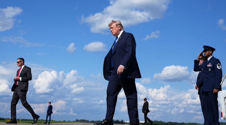 President Donald Trump, center, walks from Air Force One at Morristown Municipal Airport in Morristown, N.J., Friday, July 31, 2026, from Camp David, the presidential retreat. (AP Photo/Jacquelyn Martin)