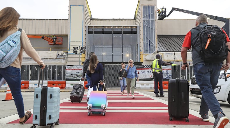 October 8, 2018 Hartsfield-Jackson International Airport: Monday air travelers discovered the beginnings of canopy work Oct. 8, 2018 that included road closures that began Saturday at the busy Delta Air Lines curbside at Hartsfield-Jackson International, as the airport started construction of a massive canopy at Terminal South. On Saturday morning, parts of the upper roadway at Terminal South were closed, and the entire upper roadway will be closed most nights, according to Hartsfield-Jackson. While road closures at Terminal North for the past year have caused traffic headaches for travelers during construction of the first of the two canopies on either side of the building, the road closures over the next year at Terminal South will disrupt even more people. Atlanta-based Delta makes up more than 80 percent of all airline passenger traffic at Hartsfield-Jackson. Hartsfield-Jackson’s interim assistant general manager of planning and development Tom Nissalke said in a written statement that the airport is “working with our partners to implement traffic mitigation efforts to ease the impact of the construction process. Airport officials recommended that travelers “seek alternate locations for drop-offs and pickups” — particularly during evening construction — adding that the airport’s hourly parking decks “allow for quick, efficient pickups for arriving passengers.” The parking decks cost $3 an hour for the first two hours. They sometimes reach capacity during busy periods of the day. While the airport has a free cell phone lot at Terminal South, traffic congestion can make it difficult to navigate to the curb. “Lessons learned from the North construction will be implemented on the South,” including traffic mitigation and the method to raise steel, said Hartsfield-Jackson spokesman Andrew Gobeil. It’s expected to be a year before the Terminal South canopy is completed in fall 2019. JOHN SPINK/JSPINK@AJC.COM