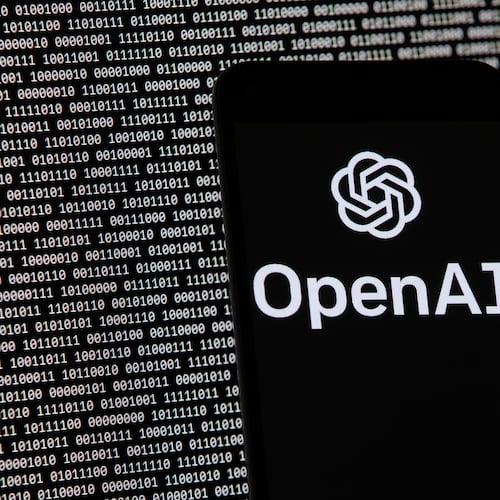 FILE - The OpenAI logo appears on a mobile phone in front of a computer screen with random binary data, March 9, 2023, in Boston. (AP Photo/Michael Dwyer, File)