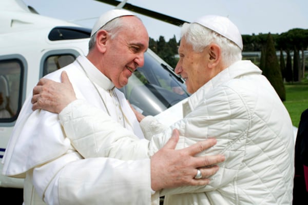 FILE - Pope Francis, left, meets Pope emeritus Benedict XVI in Castel Gandolfo, Italy, on Saturday, March 23, 2013. Emeritus Pope Benedict XVI has emerged from his self-imposed silence inside the Vatican to publish a lengthy letter to one of Italy's most well-known atheists. In it, he defends his record on handling sexually abusive priests and discusses everything from evolution to theology to the figure of Jesus Christ. Excerpts of the letter were published Tuesday, Sept. 24, 2013 by La Repubblica, the same newspaper which just two weeks ago published a similar letter from Pope Francis to its own atheist publisher. The letters indicate the two men in white, who live across the Vatican gardens from one another, are pursuing a collaborative campaign of sorts to engage non-believers. (AP Photo/Pool Photo via AP, file)