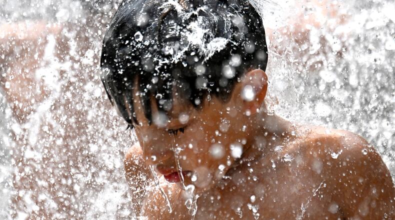 Lian Barber, 8, plays in a splash fountain at Historic Fourth Ward Park, Tuesday, June 24, 2025. Atlanta is well-known for its heat and humidity, which come with some temperature-related dangers. (Hyosub Shin / AJC)