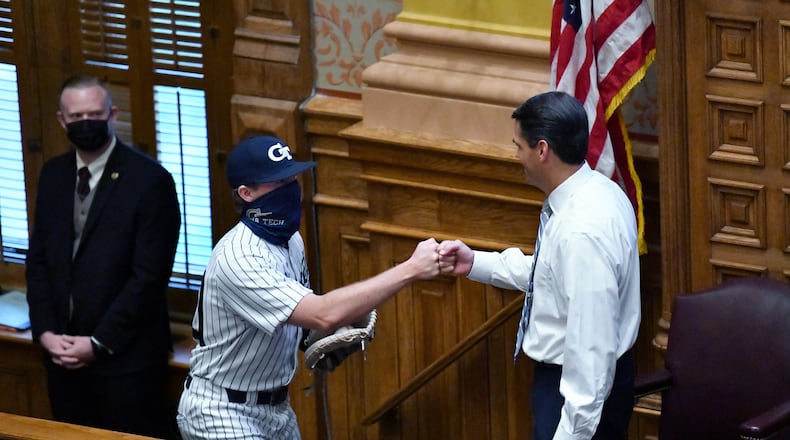 March 31, 2021 Atlanta - Lieutenant Governor Geoff Duncan exchanges fist-bumps with Georgia Tech's Jamie Taylor after he threw a baseball as the last day of the legislative session begins in the Senate Chambers at the Georgia State Capitol building in Atlanta on Wednesday, March 31, 2021. (Hyosub Shin / Hyosub.Shin@ajc.com)