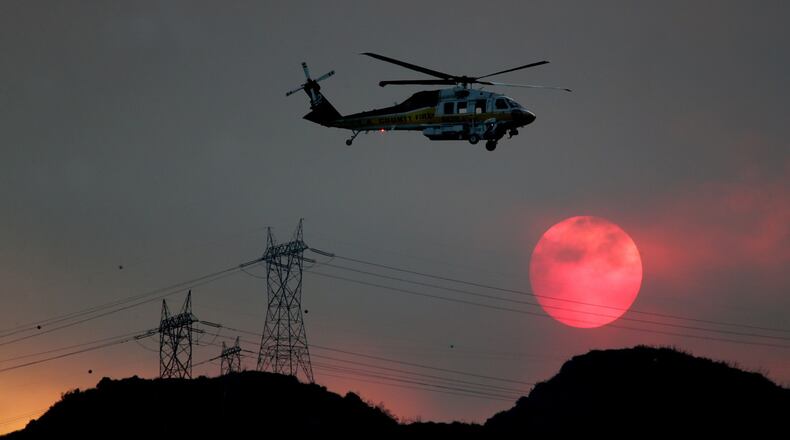 A firefighting helicopter (actual one not pictured) with four people on board crashed near an airport in central Florida, killing at least one person, officials said. (Luis Sinco/TNS)