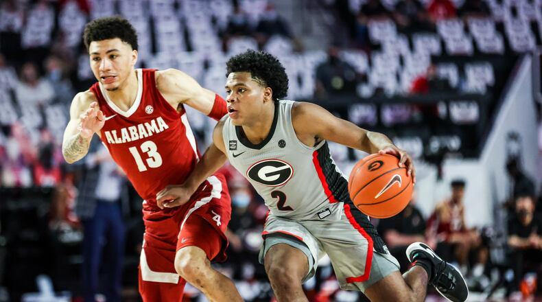Georgia sophomore guard Sahvir Wheeler (2) drives on Alabama's Jahvon Quinerly on Saturday, March 6, 2021, at Stegeman Coliseum in Athens. Wheeler logged another 'double-double' with 18 points and 10 assists, but the Bulldogs fell to the No. 8-ranked Crimson Tide 89-79. (Photo by Tony Walsh/UGA Athletics)