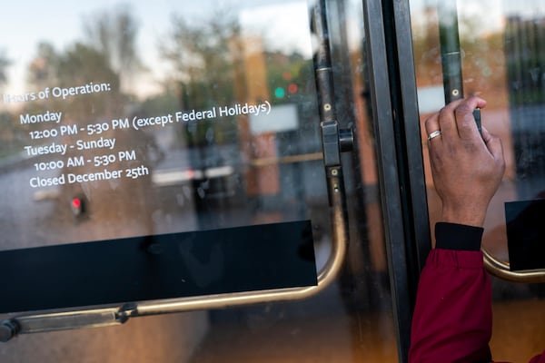 Pastor Robert Turner prays in front of the National Museum of African American History and Culture as part of his monthly walk from Baltimore to Washington to raise awareness of reparations on Wednesday, April 16, 2025, in Washington. (AP Photo/Nathan Howard)