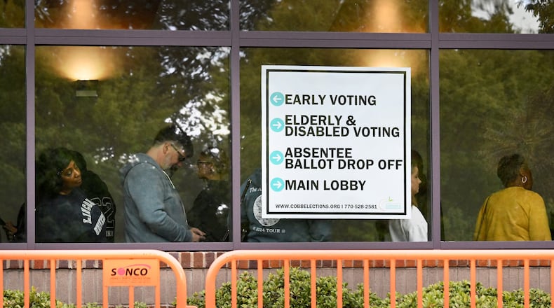 Voters line up as they arrive at an early voting location in Marietta on the first day of early voting. The county acknowledged it has not yet mailed ballots to more than 3,000 voters — though the deadline to return the ballots is Tuesday. (Hyosub Shin / AJC)