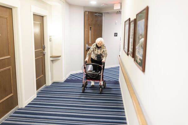 Resident Florence Reiners navigates a hallway of the Waters of Excelsior assisted living facility in Excelsior, Minnesota. (Tim Gruber for The New York Times)