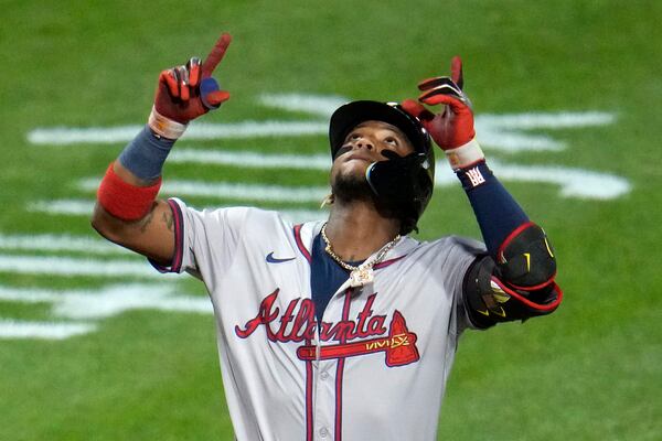 Atlanta Braves' Ronald Acuña Jr. celebrates as he crosses home plate on a three-run home run off Pittsburgh Pirates starting pitcher Bailey Falter during the eighth inning of a baseball game in Pittsburgh, Friday, May 24, 2024. (AP Photo/Gene J. Puskar)