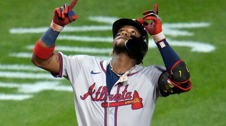 Atlanta Braves' Ronald Acuña Jr. celebrates as he crosses home plate on a three-run home run off Pittsburgh Pirates starting pitcher Bailey Falter during the eighth inning of a baseball game in Pittsburgh, Friday, May 24, 2024. (AP Photo/Gene J. Puskar)
