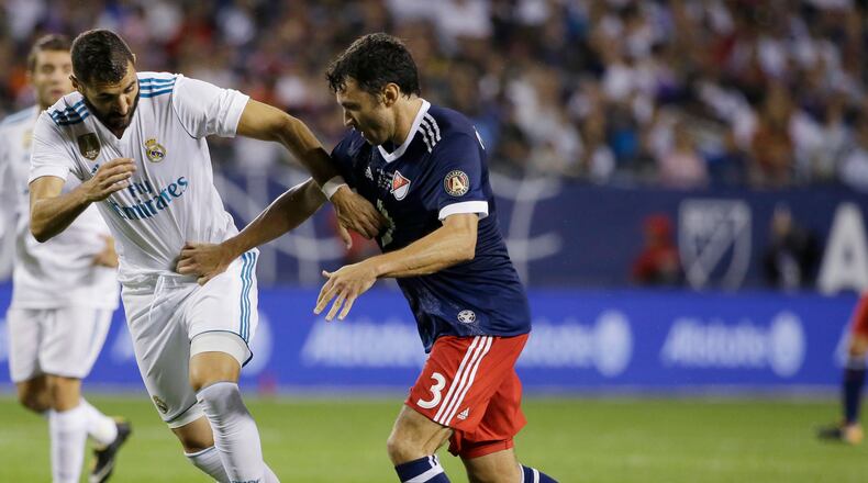 Real Madrid's Karim Benzema, left, and MLS All-Stars' Michael Parkhurst vie for the ball during the second half of the MLS All-Star Game, Wednesday, Aug. 2, 2017, in Chicago. Real Madrid won the game. (AP Photo/Nam Y. Huh)