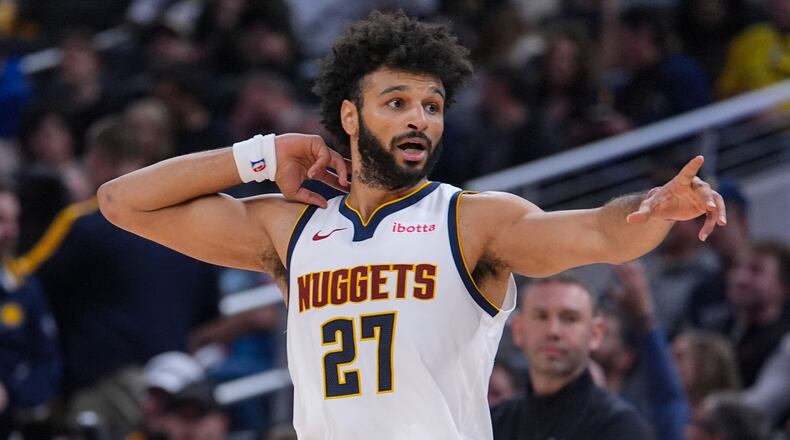 Denver Nuggets guard Jamal Murray (27) reacts after scoring his 50th point against the Indiana Pacers during the second half of an NBA basketball game in Indianapolis, Wednesday, Dec. 3, 2025. (AP Photo/Michael Conroy)