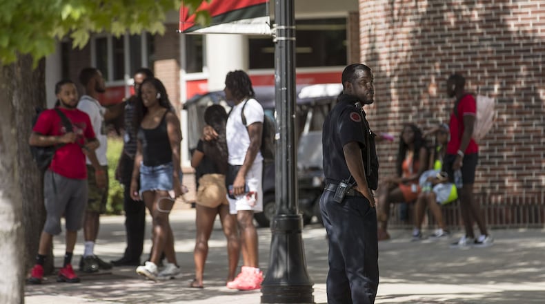 08/21/2019 — Atlanta, Georgia — A Clark Atlanta University Police officer keeps an eye out as students socialize near the Clark Atlanta University student center on the main campus in Atlanta, Wednesday, August 21, 2019. Tuesday night a shooting took place on the promenade, an area near the library, injuring 2 Clark Atlanta University students and 2 Spelman College students. The students did not face any life threatening injuries and were treated at Grady Memorial hospital for their wounds. (Alyssa Pointer/alyssa.pointer@ajc.com)