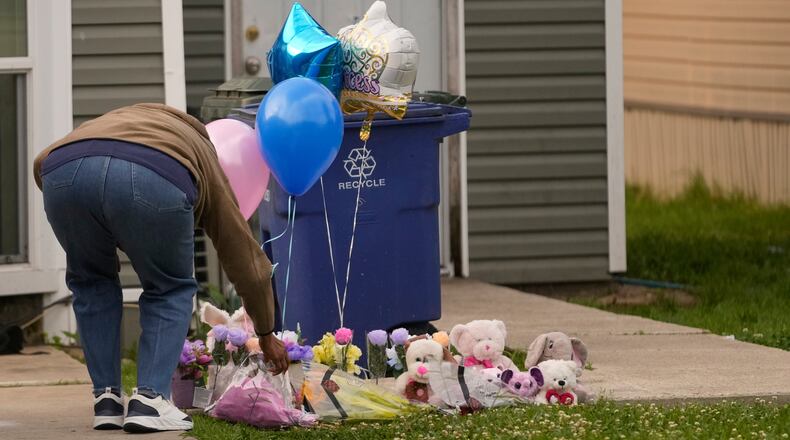 A person leaves a gift at a makeshift memorial on the front lawn of the home where children were killed during a mass shooting the day before in Shreveport, La., Monday, April 20, 2026. (AP Photo/Gerald Herbert)