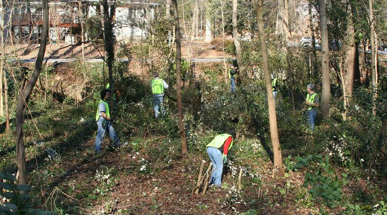 Work in Parkwood Park several years ago in Decatur’s Parkwood neighborhood. In the background is West Parkwood Rd. one of several area streets getting traffic calming improvements beginning this week. Courtesy of Erin Elmore of the Parkwood Garden Club