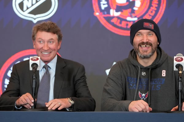 Former NHL player Wayne Gretzky, left, with Washington Capitals Alex Ovechkin, right, during a press conference after an NHL hockey game in which Ovechkin tied Gretzky's NHL career goals record of 894th goals, Friday, April 4, 2025, in Washington.(AP Photo/Mark Schiefelbein)