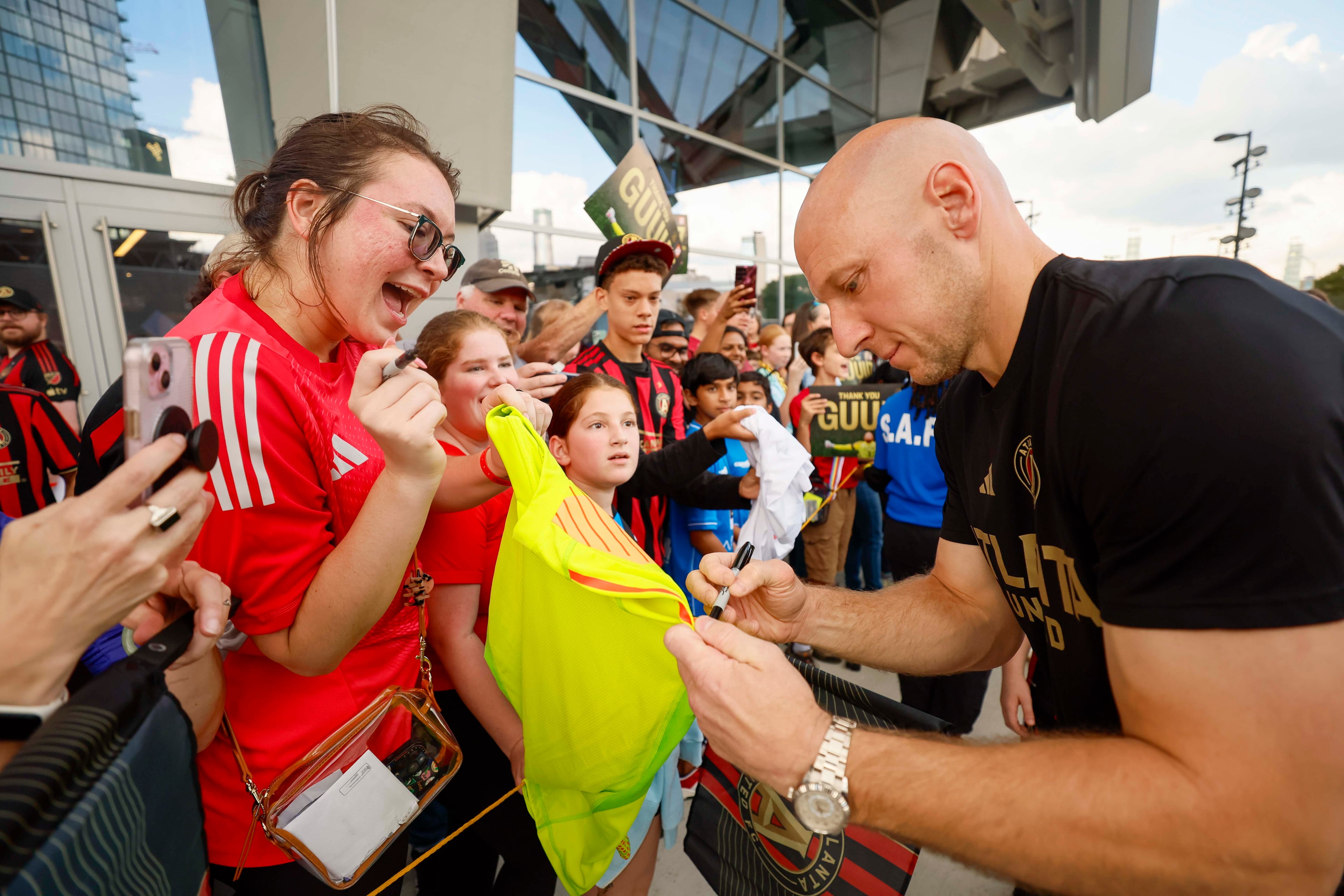An Atlanta United fan reacts as Atlanta United goalkeeper Brad Guzan (1) signs her jersey prior to the game against D.C. United at Mercedes-Benz Stadium on October 18, 2025, in Atlanta, GA.
(Miguel Martinez/ AJC)