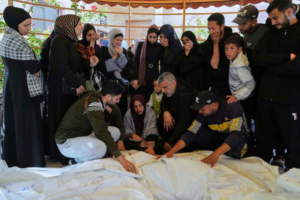 Palestinians react next to the bodies of their relatives, killed in an Israeli army strike, before their burial at a hospital in Khan Younis, Gaza Strip on Wednesday, April 2, 2025. (AP Photo/Abdel Kareem Hana)
