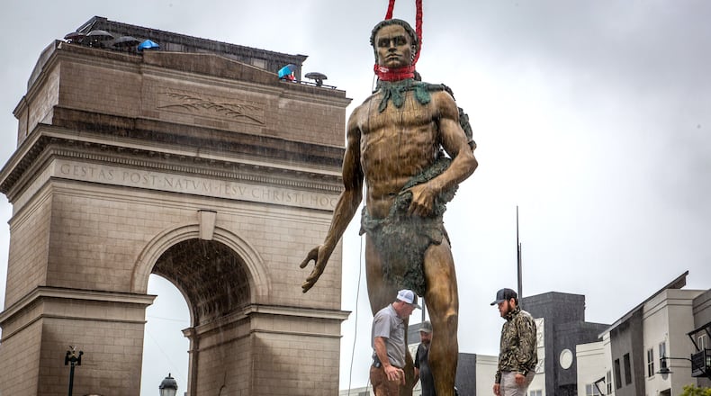 Workers temporarily install the statue of Tomochichi, chief of the Yamacraw, at the Millennium Gate Museum on 17th St. Monday, September 20, 2021.  STEVE SCHAEFER FOR THE ATLANTA JOURNAL-CONSTITUTION
