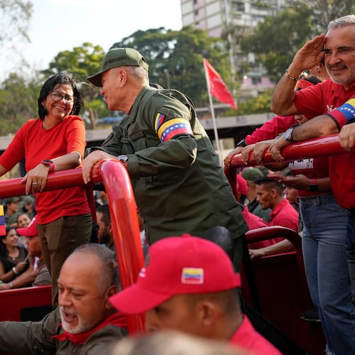 FILE - Vice President Delcy Rodriguez, left, smiles at Venezuelan Defense Minister Padrino Lopez, as they take the route that the body of late President Hugo Chavez was transported to his final resting place, during the activities marking the 10th anniversary of Chavez's death, in Caracas, Venezuela, March 15, 2023. (AP Photo/Matias Delacroix, File)
