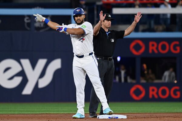 Toronto Blue Jays left fielder Anthony Santander (25) gestures to the dugout after hitting a double against the Atlanta Braves batter in the first inning of an interleague baseball game in Toronto, Wednesday, April 16, 2025. (Jon Blacker/The Canadian Press via AP)