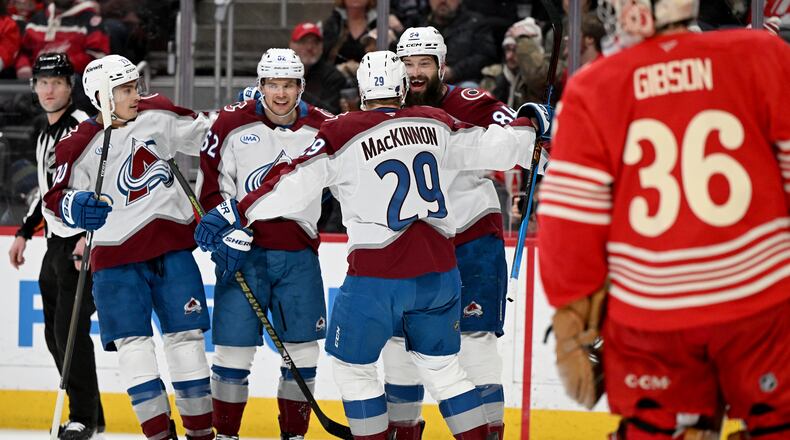 Colorado defenseman Brent Burns (84) celebrates with Colorado defenseman Sam Malinski (70), Colorado left wing Artturi Lehkonen (62) and Colorado center Nathan MacKinnon (29) after scoring a goal against Detroit in the first period of an NHL hockey game Saturday, Jan. 31, 2026 in Detroit. (AP Photo/Lon Horwedel)