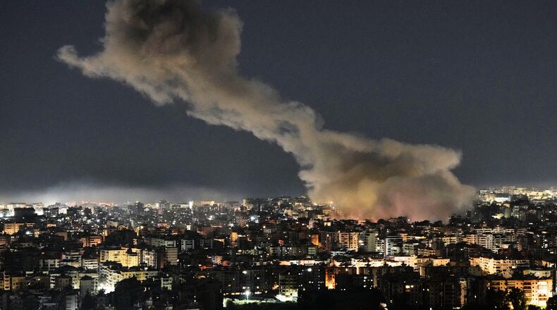 File - Smoke rises from Israeli airstrikes that struck a building housing Al-Manar channel studios in Dahiyeh, a southern suburb of Beirut, Lebanon, early on Tuesday, March 3, 2026. (AP Photo/Bilal Hussein, File)