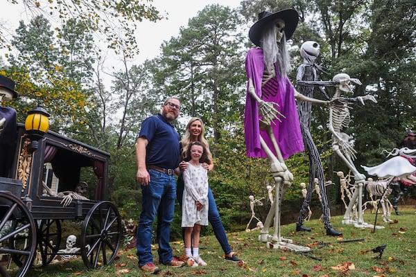 Cumming residents Brent and Kathleen Ridley, and their daughter, Harper, are avid collectors of Home Depot's Halloween decorations. (Abbey Cutrer/AJC) 