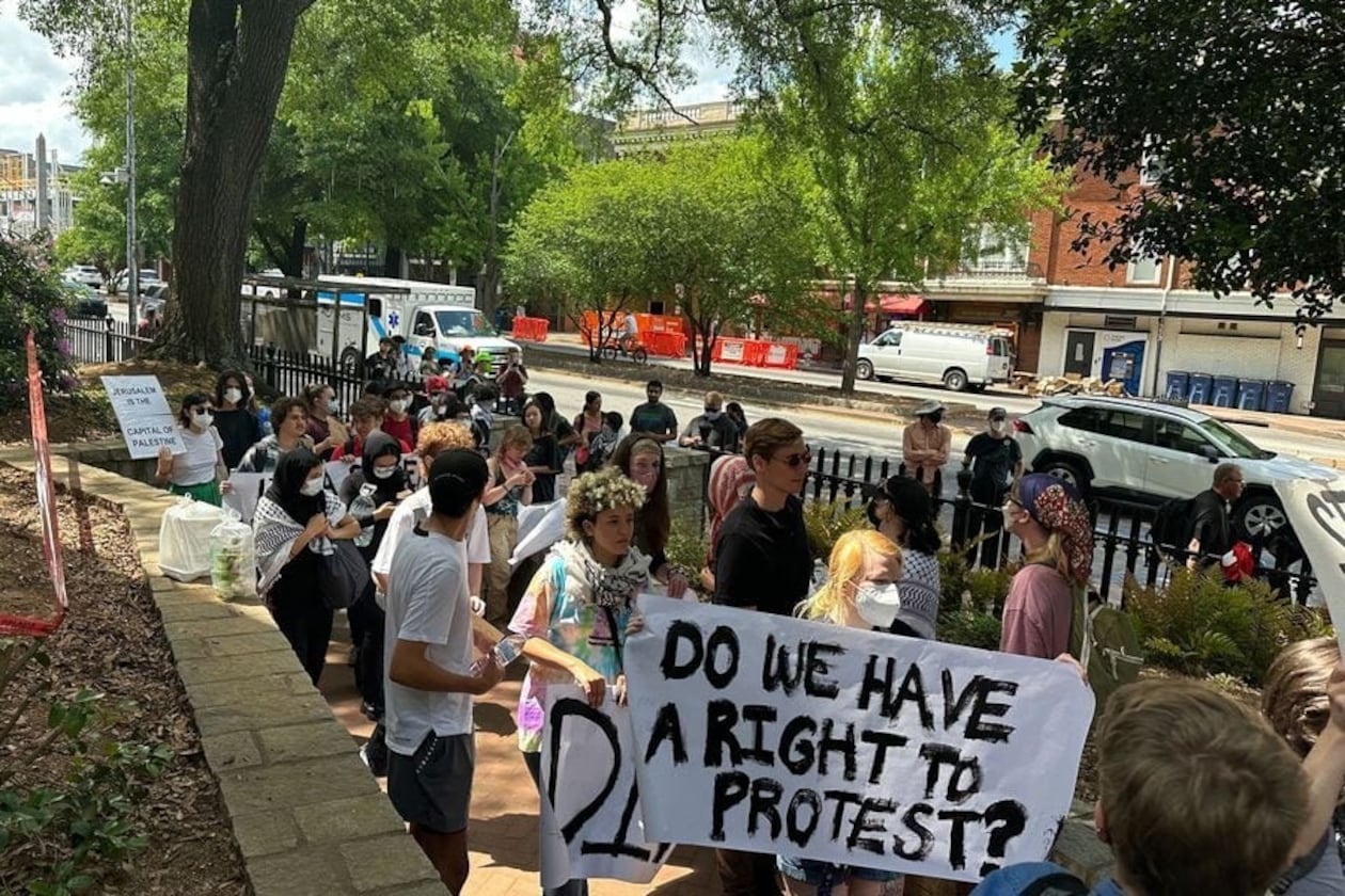 Demonstrators protesting the Israel-Hamas war in Gaza carry a banner asking "Do we have a right to protest?" at the University of Georgia in 2024. The University System of Georgia on July 1 published its annual free speech report, which stated that schools prepared extensively for campus protests. (Fletcher Page/AJC file photo)