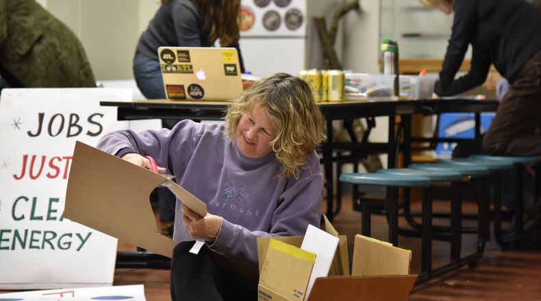 January 12, 2017 Decatur - Brenda Constan (foreground) uses scissors to cut out a hand shape to create an unique sign during a sign-making session for people marching in the Atlanta Social Justice and Women’s March on January 21, at Georgia Sierra Club on Thursday, January 12, 2017. HYOSUB SHIN / HSHIN@AJC.COM