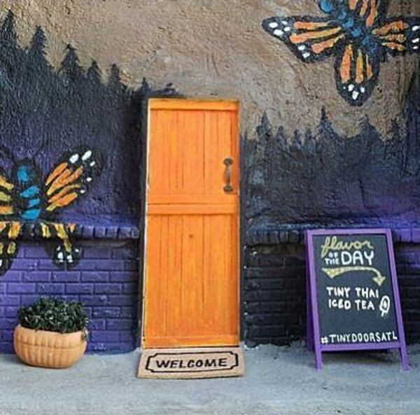 This tiny door is located near the King of Pops walk-up window. The message on the tiny sandwich board is changed weekly.