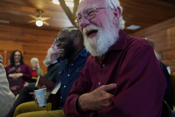 Bridge Hill Kennedy, left, and Jesse Roberts, right, laugh between songs from the bass section at a Sacred Harp singing event at Holly Springs Primitive Baptist Church in Bremen, Ga., on Saturday, March 22, 2025. (AP Photo/Jessie Wardarski)