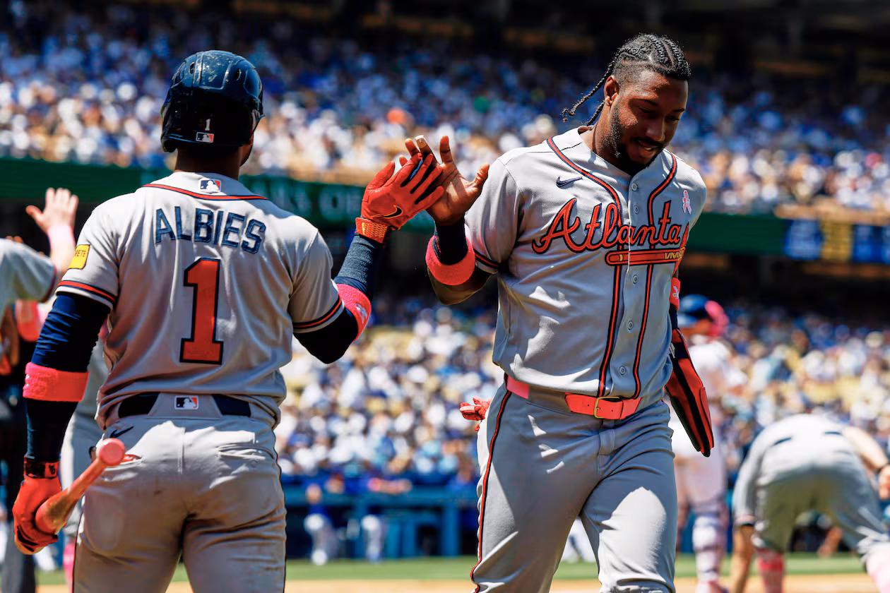 Atlanta Braves' Jorge Mateo, right, is greeted by Ozzie Albies (1) on a a two-run double by Atlanta Braves' Mauricio Dubon during the second inning of a baseball game against the Los Angeles Dodgers, Sunday, May 10, 2026, in Los Angeles. (AP Photo/Caroline Brehman)