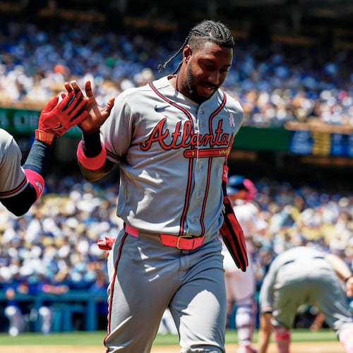 Atlanta Braves' Jorge Mateo, right, is greeted by Ozzie Albies (1) on a a two-run double by Atlanta Braves' Mauricio Dubon during the second inning of a baseball game against the Los Angeles Dodgers, Sunday, May 10, 2026, in Los Angeles. (AP Photo/Caroline Brehman)