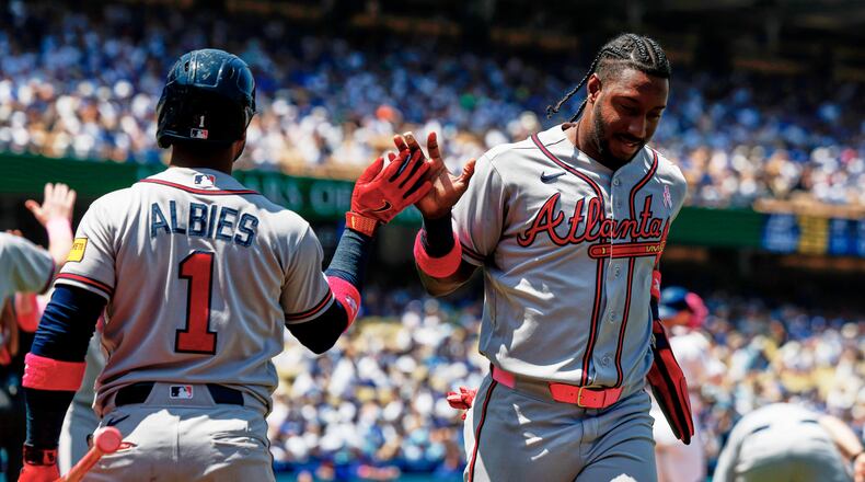 Atlanta Braves' Jorge Mateo is greeted by Ozzie Albies on a two-run double by Mauricio Dubon during the second inning against the Los Angeles Dodgers on May 10, 2026. (Caroline Brehman/AP)
