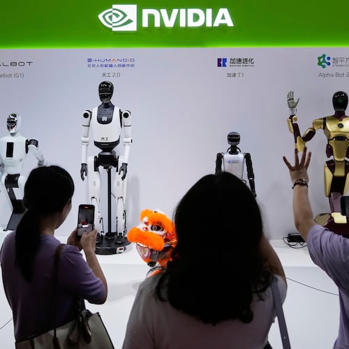 FILE - Visitors give commands to robots at Nvidia's booth during the China International Supply Chain Expo at the China International Exhibition Center in Beijing, China, July 18, 2025. (AP Photo/Mahesh Kumar A., File)