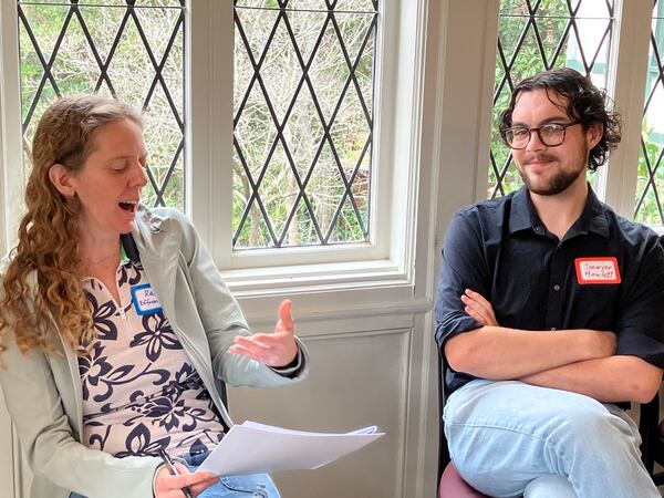 Gwinnett immigration attorney Rachel Effron Sharma (left) talks with Sawyer Howlett of Clarkston. The group broke into red/blue pairs with the instruction to share a policy each one supports and pose one question to each other. (Courtesy of Stell Simonton)
