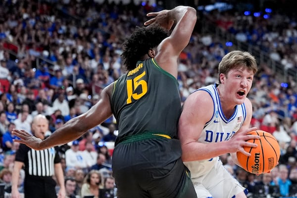 Duke guard Kon Knueppel drives to the basket past Baylor forward Norchad Omier during the first half in the second round of the NCAA college basketball tournament, Sunday, March 23, 2025, in Raleigh, N.C. (AP Photo/Chris Carlson)