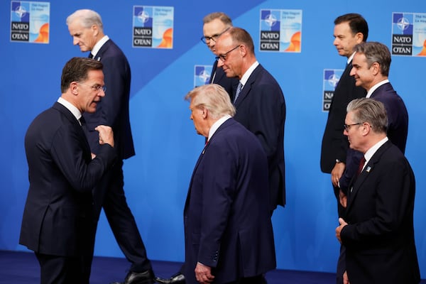 NATO Secretary General Mark Rutte, left, speaks with President Donald Trump, center, and Britain's Prime Minister Keir Starmer, right, after a group photo of NATO heads of state and government at the NATO summit in The Hague, Netherlands, Wednesday, June 25, 2025. (AP Photo/Geert Vanden Wijngaert)