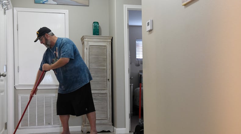 Mark Jones cleans an AirBnB, Monday, March 2, 2020, in Port Aransas, Texas. Jones' niece helped him get work when he was released from prison in 2017.