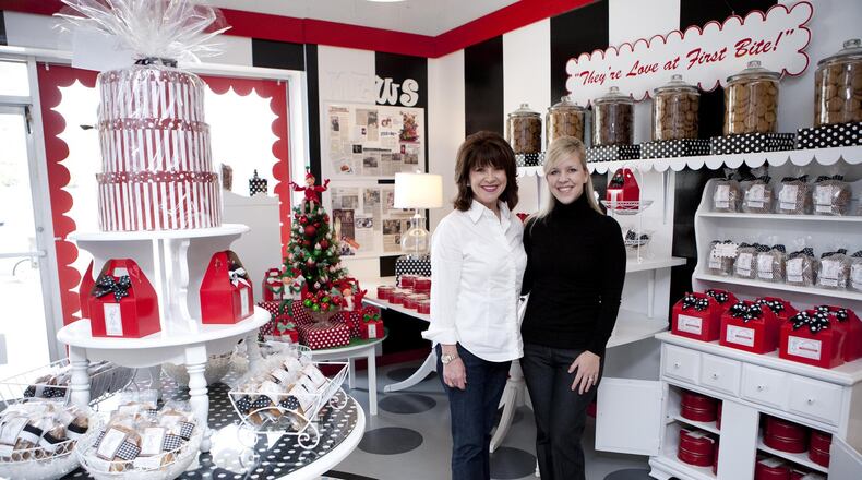 Mother-daughter entrepreneurs, Laura Stachler (right) and Susan Stachler (right), stand in their Sandy Springs cookie shop, Susansnaps. Photo by Pink Shoe Photography.