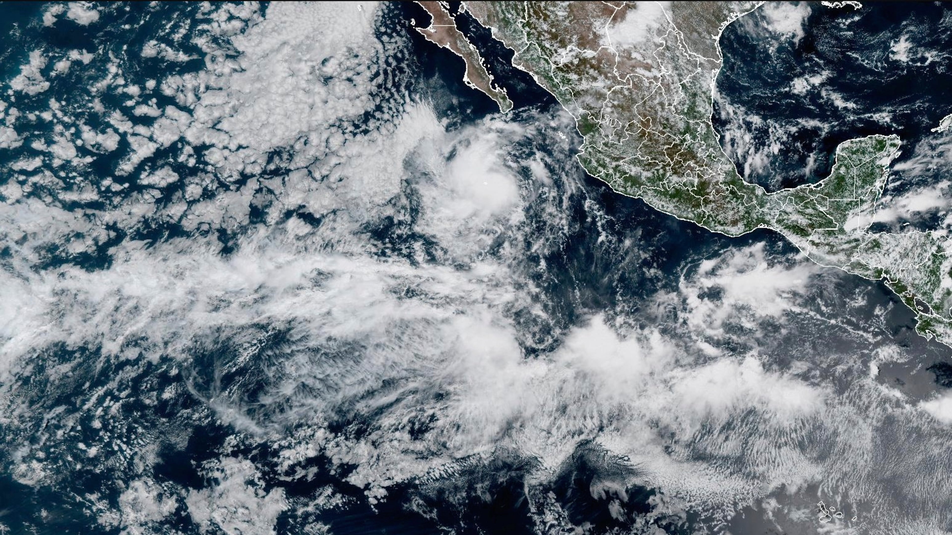 In this satellite image released by NOAA, Tropical Storm Mario is seen developing off the western Mexican coast, Sunday, Sept. 14, 2025. (NOAA via AP)