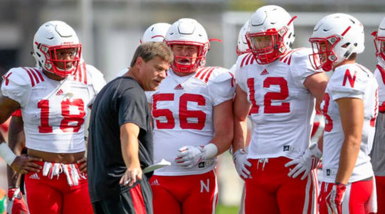 In this Aug. 23, 2016, photo, Nebraska walk-on, linebacker Brad Simpson (56) stands between Tre Bryant (18) and Luke Gifford (12) as they listen to special teams coach Bruce Read, during NCAA college football practice in Lincoln, Neb. Simpson had to think long and hard about saying no to offers of partial scholarships from Division II Nebraska-Kearney and Northwest Missouri State and saying yes to the walk-on opportunity presented by the former Nebraska staff. (AP Photo/Nati Harnik)